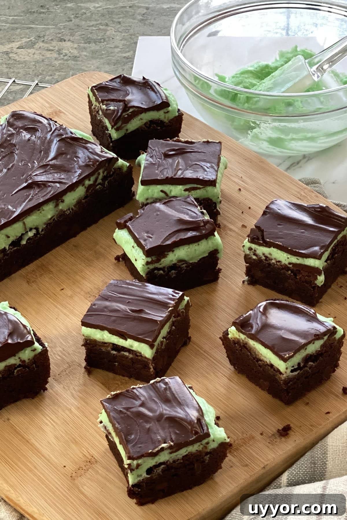 Decadent Fudgy Mint Brownies Recipe 5 a cutting board with 6 mint brownies