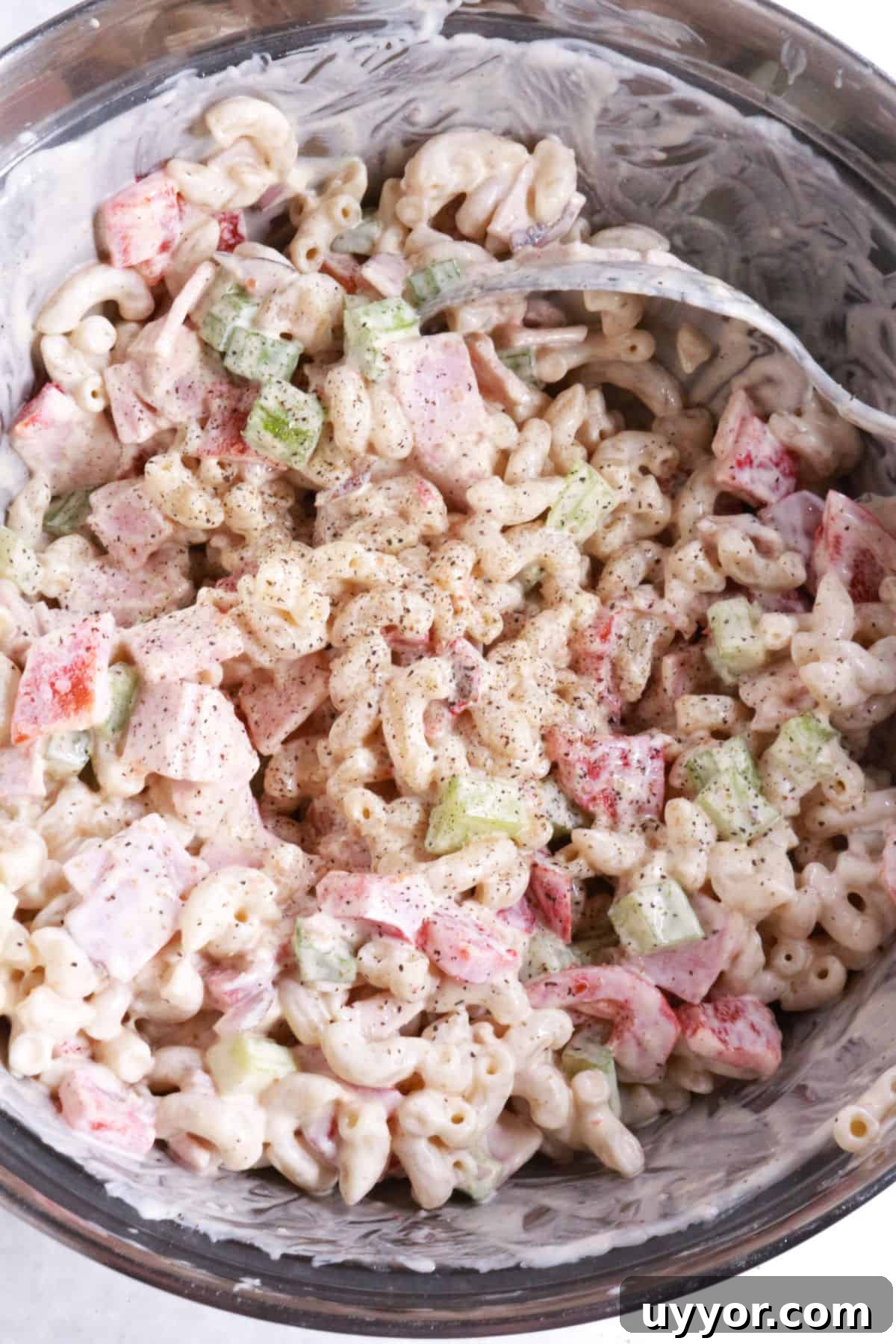 Mixing Mexican-style macaroni salad.