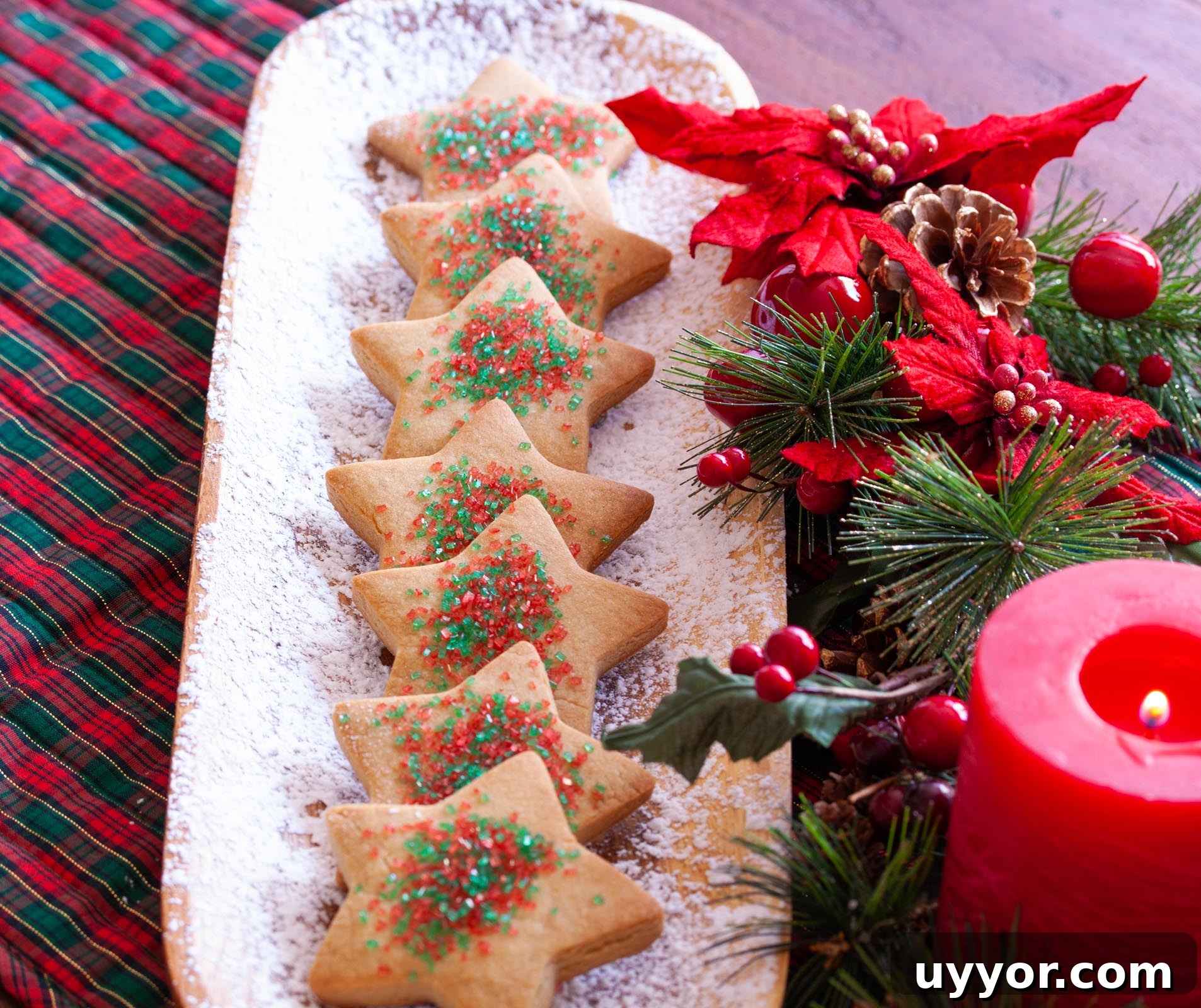 Chewy Brown Sugar Cookie Recipe You’ll Love 5 Brown sugar cookies on a white plate with Christmas poinsetta decorations and a red lite candle