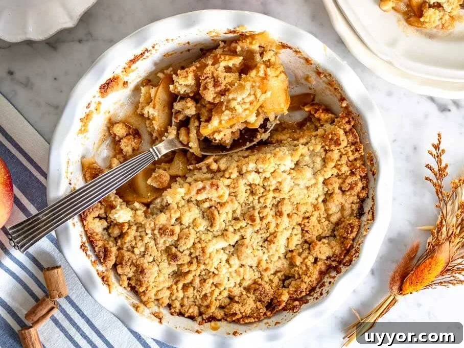 25 Cozy Apple Recipes That Capture Fall Flavors 11 Apple crumble in pie dish and a cup of coffee