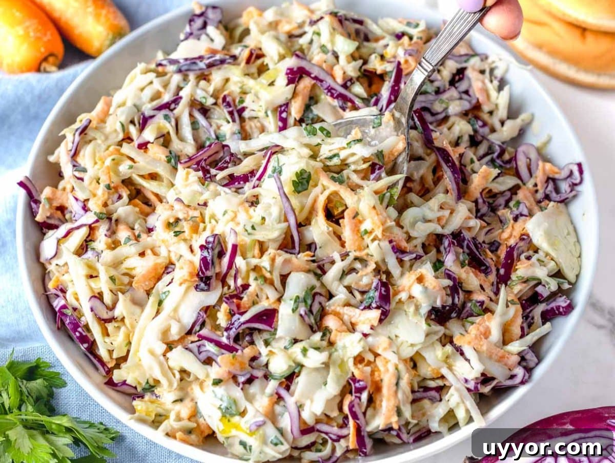25 Cozy Apple Recipes That Capture Fall Flavors 18 Healthy Greek Yogurt Coleslaw served on a white platter.