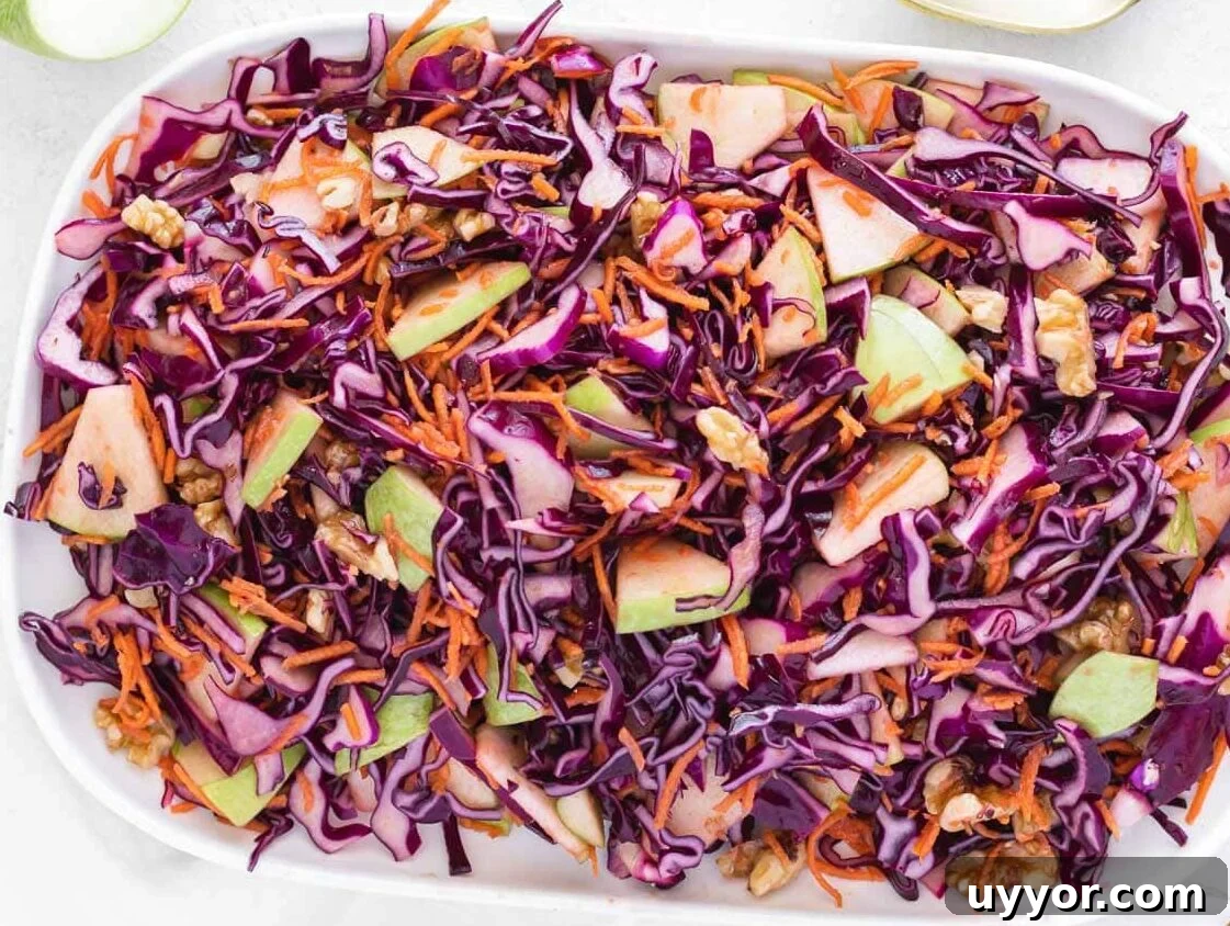 25 Cozy Apple Recipes That Capture Fall Flavors 19 vinegar coleslaw on a white serving platter