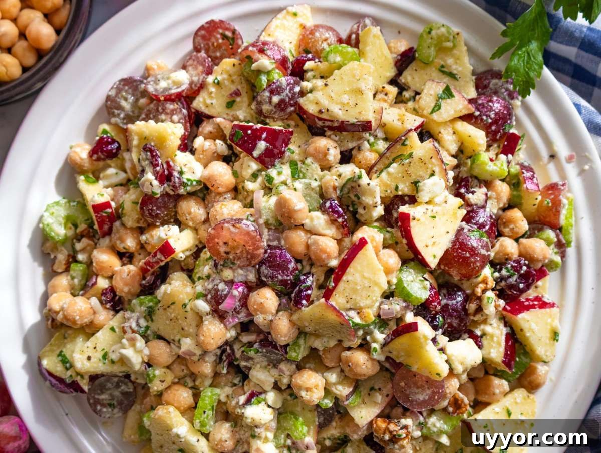 25 Cozy Apple Recipes That Capture Fall Flavors 26 Chickpea cranberry salad on platter with feta and herbs.