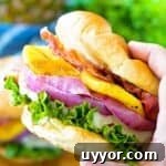 Grilled Pineapple Teriyaki Chicken Burger in hand