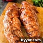 bbq pork tenderloin resting on cutting board