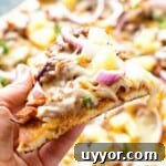 Pulled Pork Pizza Slice in hand