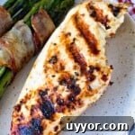Caesar Grilled Chicken Breast and bacon wrapped asparagus on plate