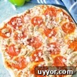 Grilled three meat pizza on counter