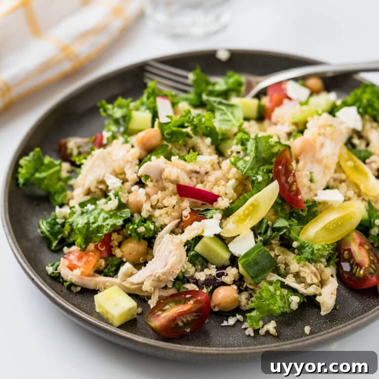 serving chicken quinoa salad on a plate.