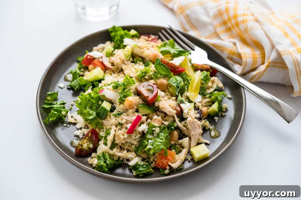 serving the kale quinoa salad on a plate.