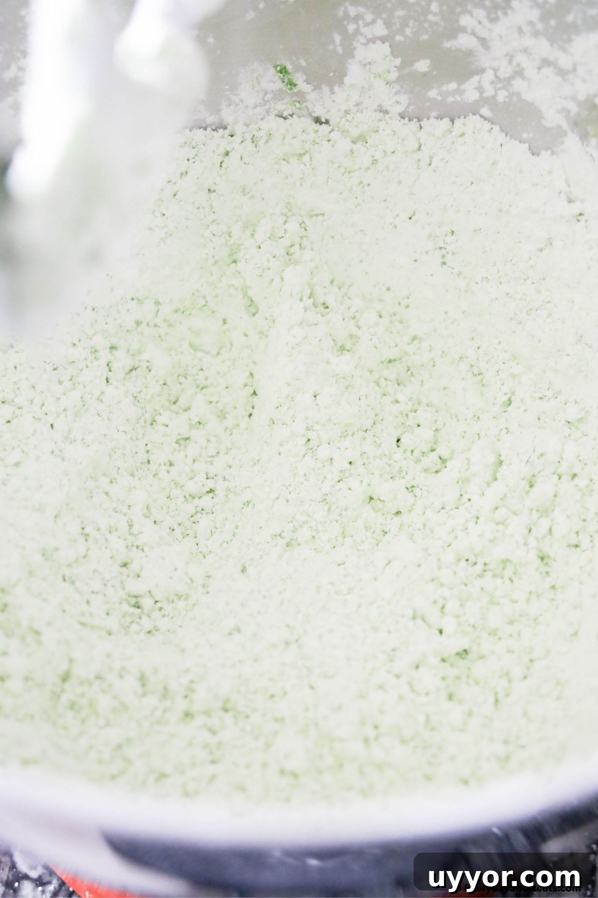Grinch Puppy Chow Holiday Snack Mix Recipe 5 green powdered sugar in a bag