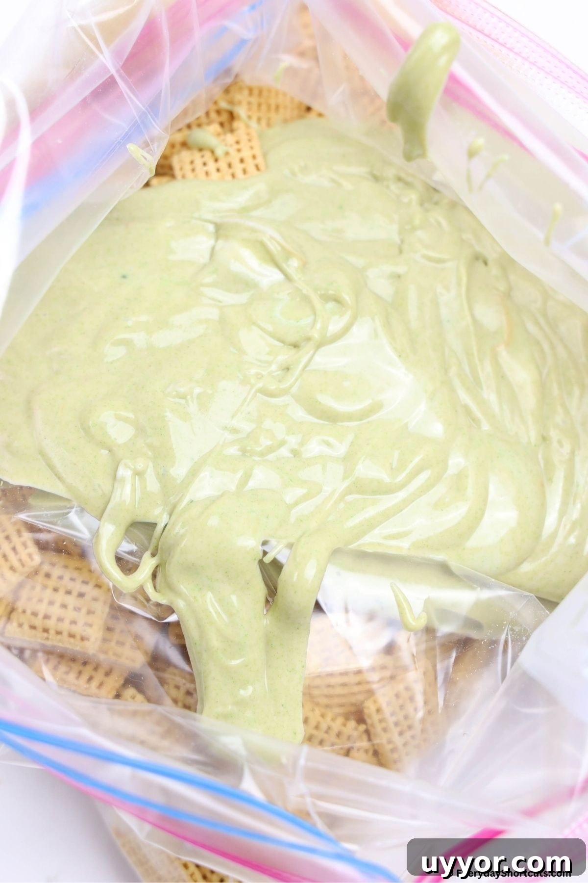 Grinch Puppy Chow Holiday Snack Mix Recipe 7 melted chocolate and chex cereal in a bag