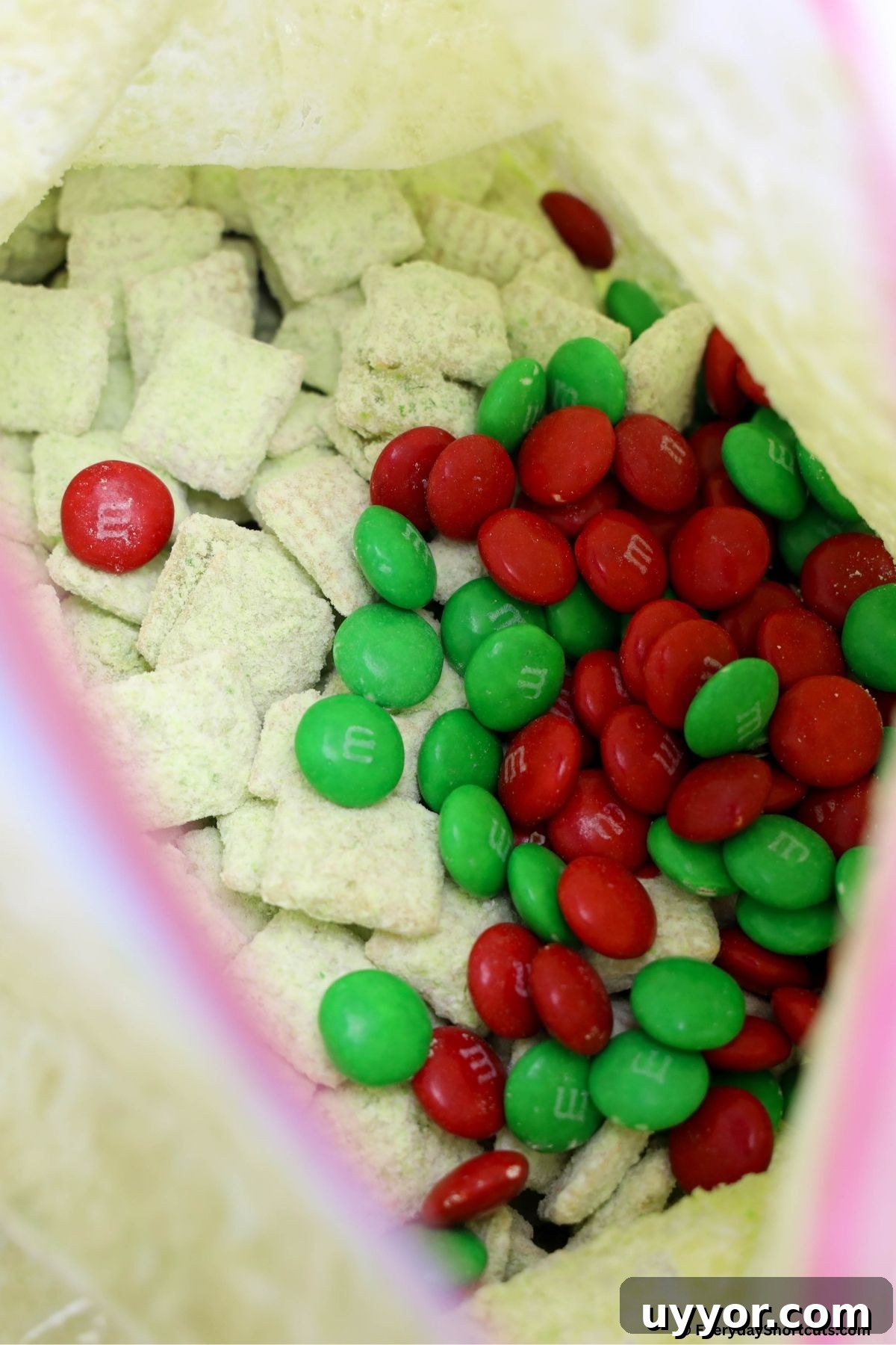 Grinch Puppy Chow Holiday Snack Mix Recipe 8 powdered sugar chex cereal and M&Ms