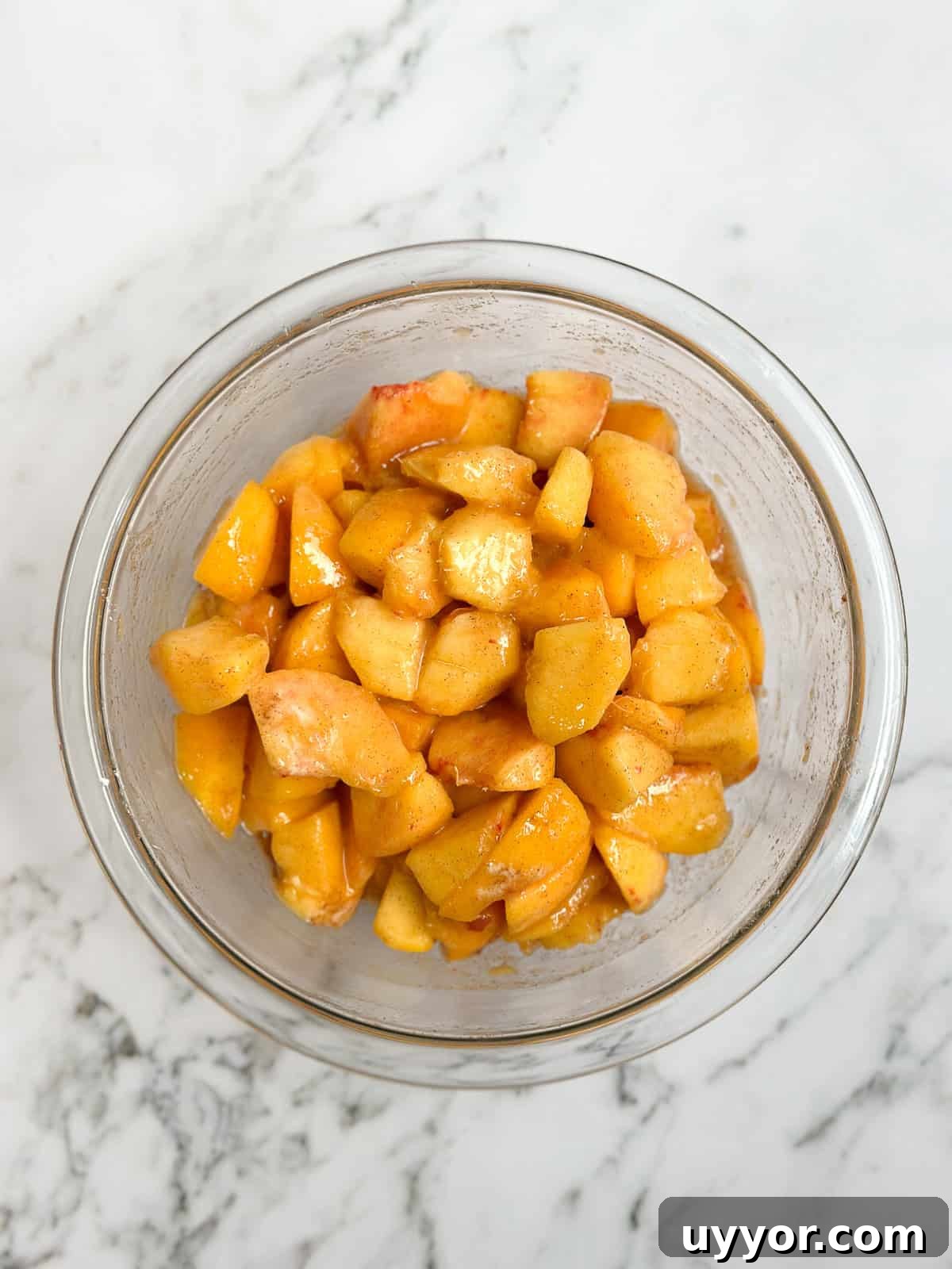 Brown Butter Peach Crisp Recipe — Warm Summer Dessert 8 peaches mixed with sugar.