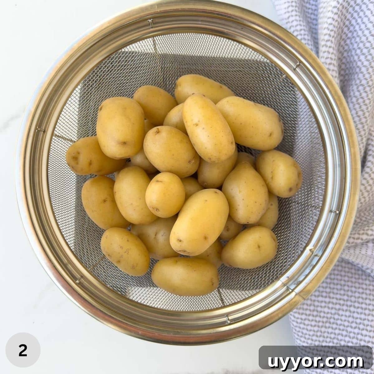 Buttery Baby Dutch Yellow Potatoes Recipe for Tender Roasted Spuds 5 Baby gold potatoes in a colander after cooking.