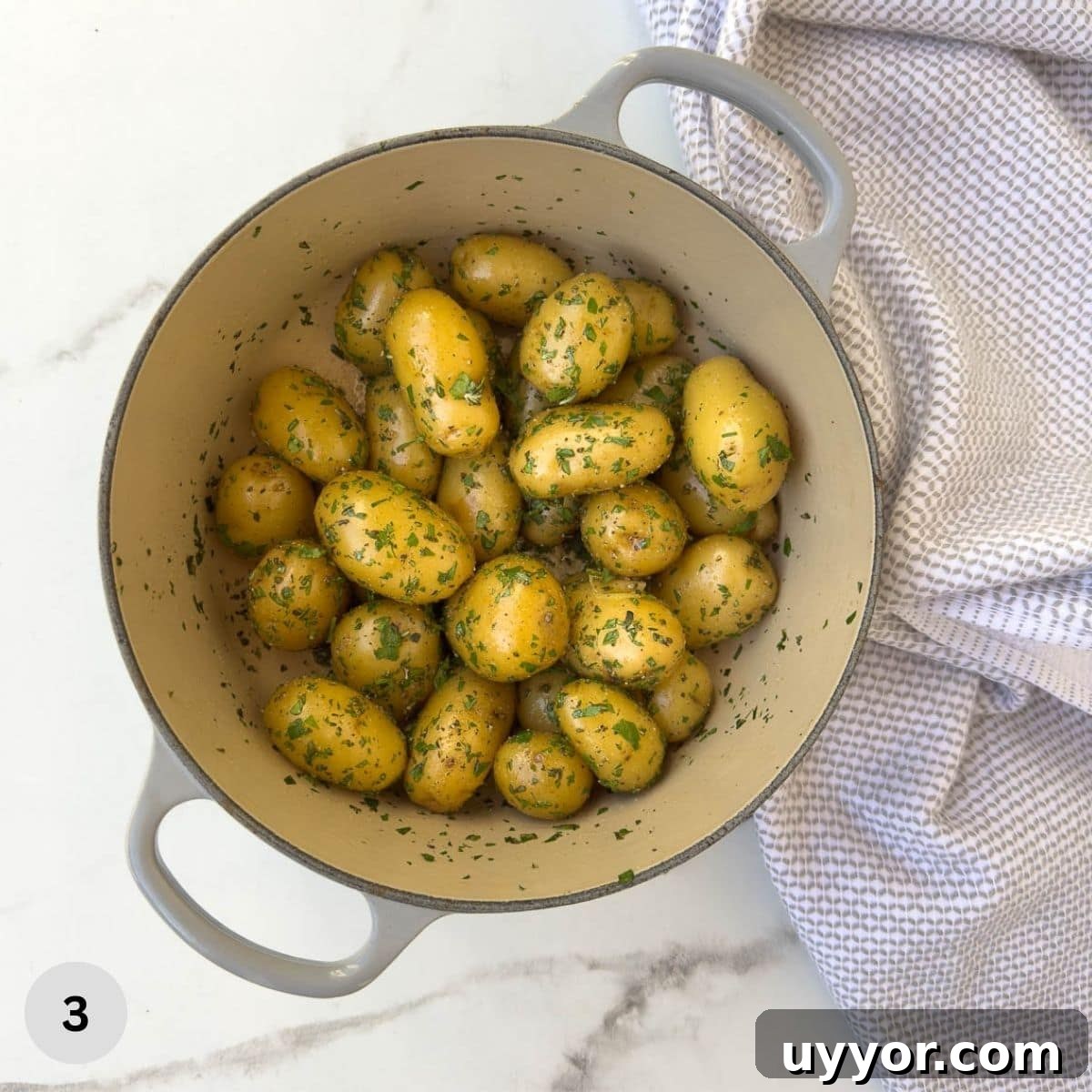Buttery Baby Dutch Yellow Potatoes Recipe for Tender Roasted Spuds 6 Cooked baby potatoes covered in fresh herbs in a pot.