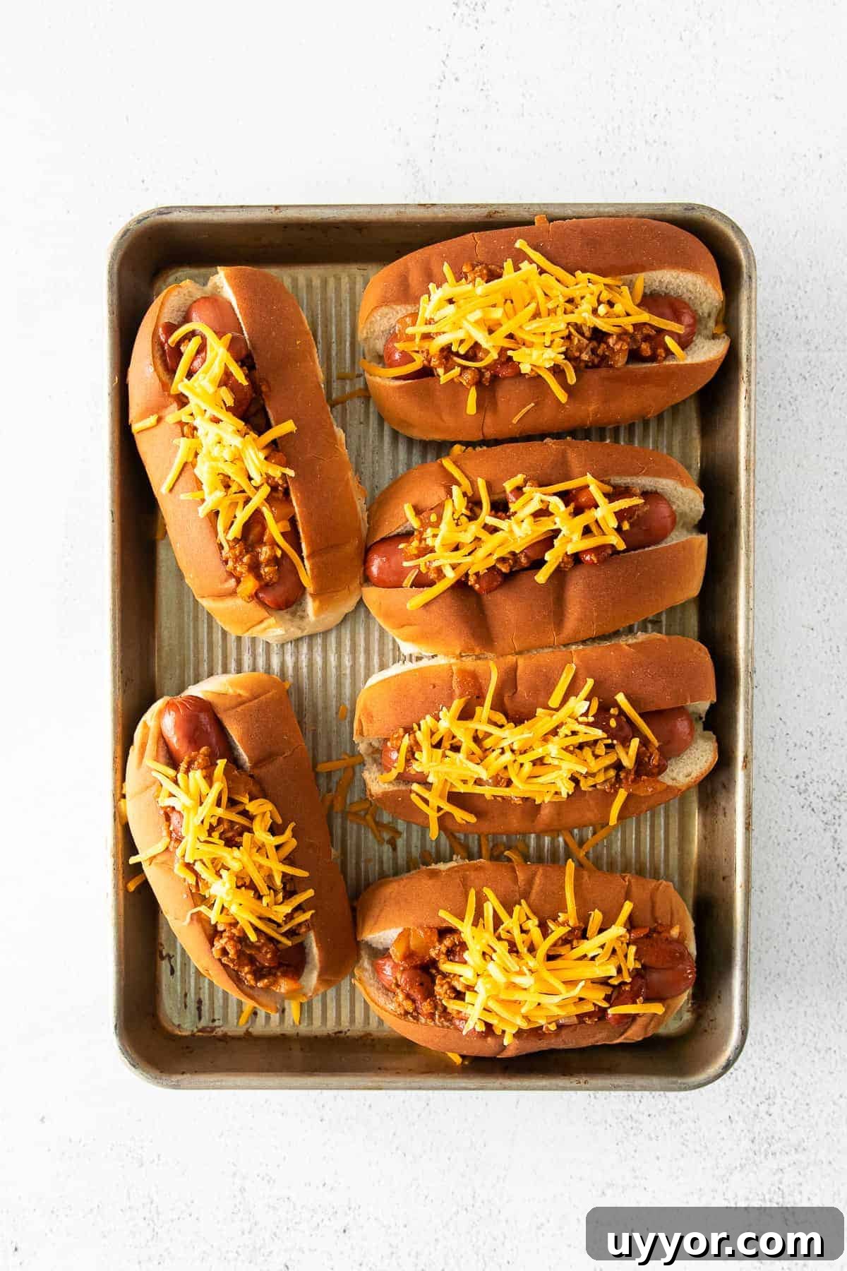 Chili cheese dogs in pan Pan of chili cheese dogs.