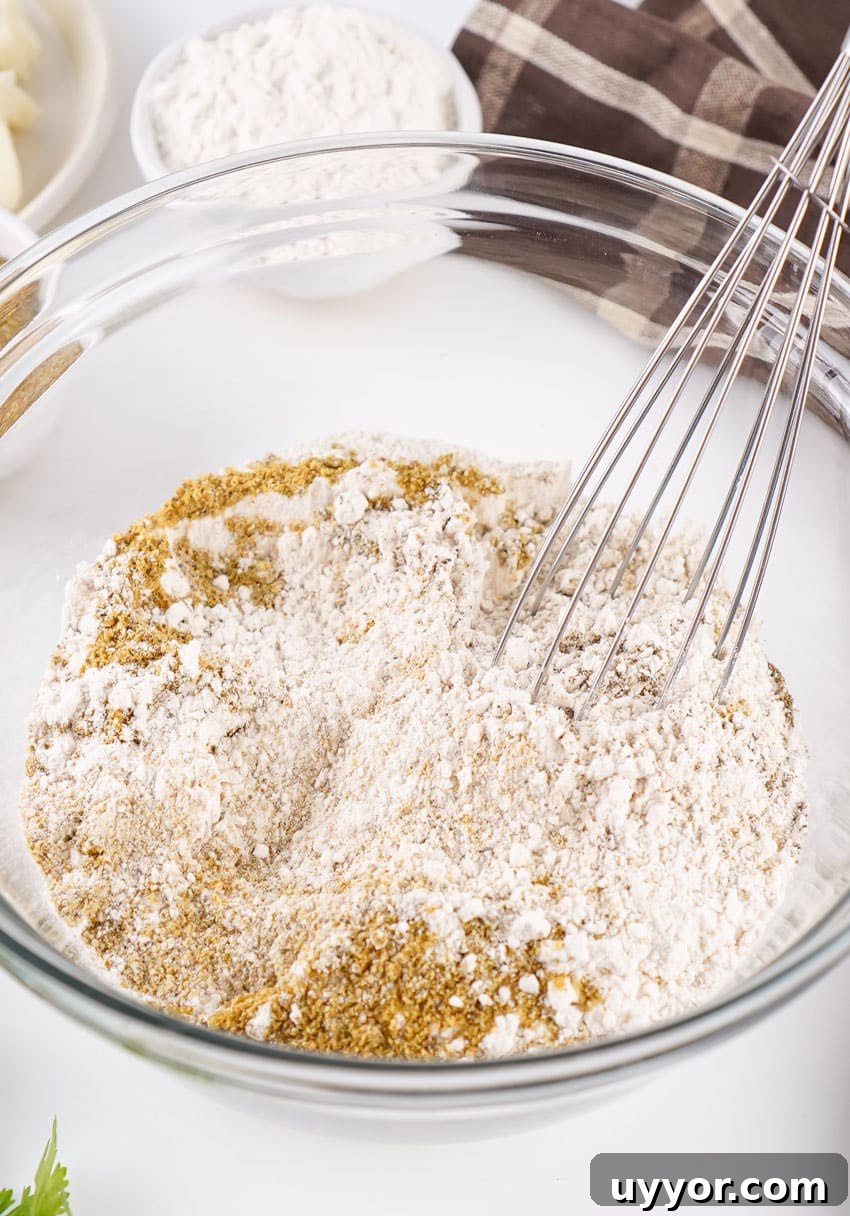 Homemade Brown Gravy Mix Recipe: Make and Store from Scratch 5 homemade brown gravy mix being whisked together in a large glass mixing bowl