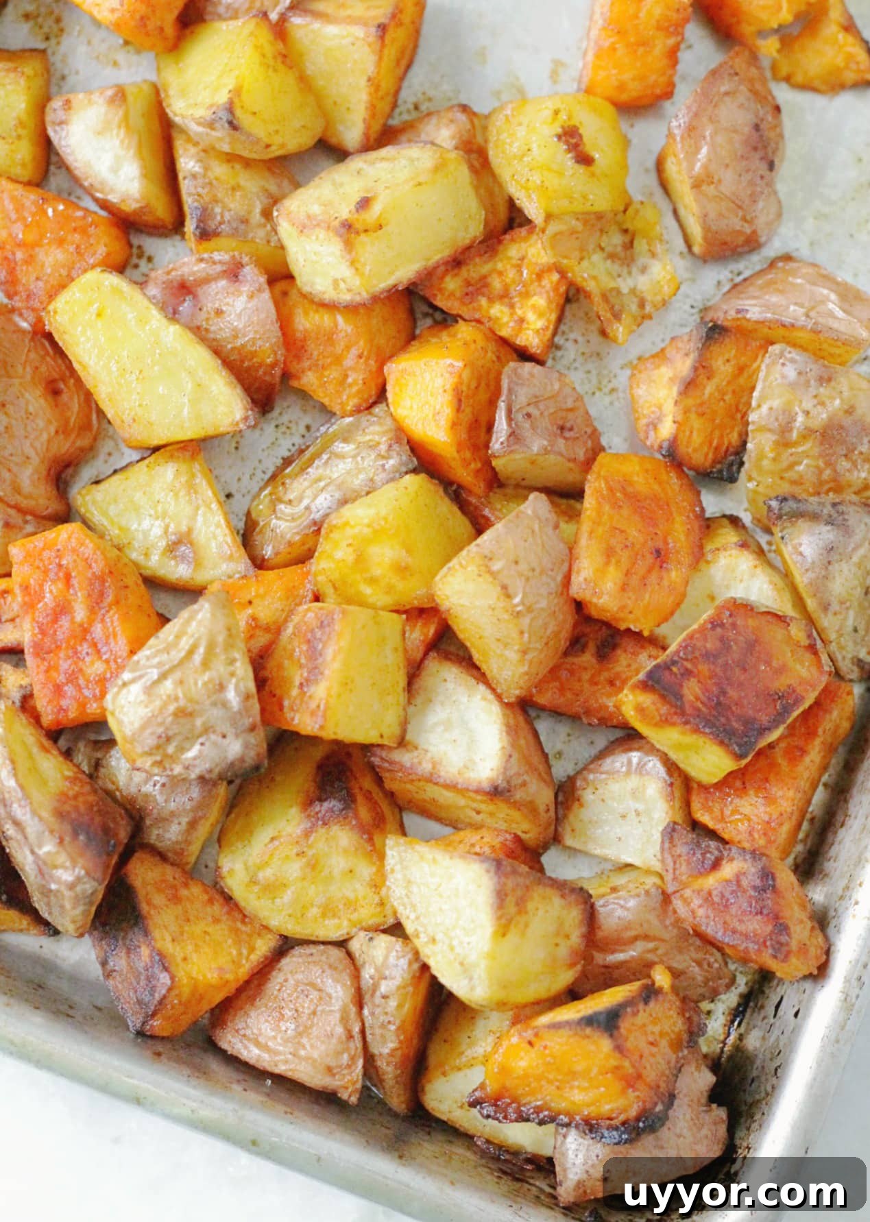 Crispy Oven-Roasted Potatoes with Creamy Herb Dipping Sauce 2 perfect oven roasted potatoes overhead view on a sheet pan