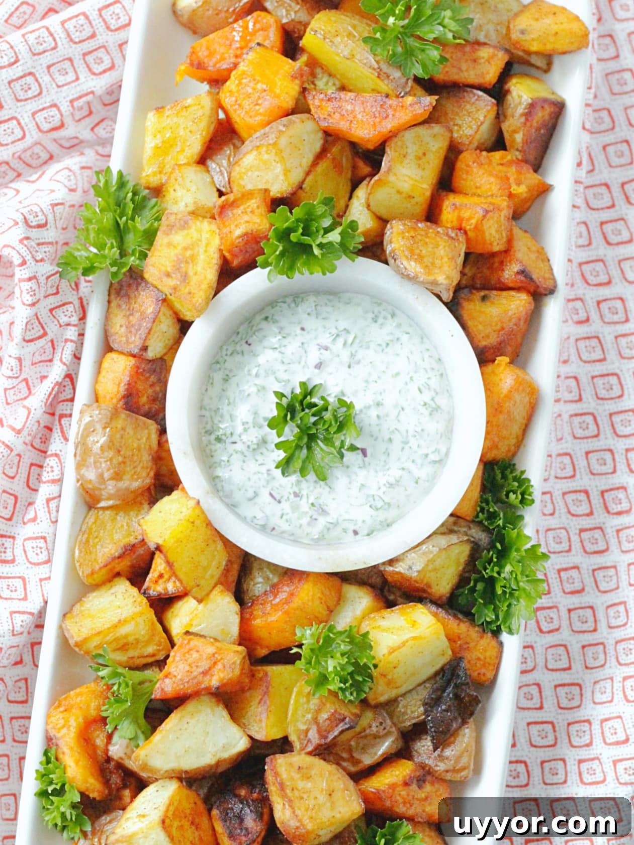 Crispy Oven-Roasted Potatoes with Creamy Herb Dipping Sauce 3 overhead view of perfect oven roasted potatoes on platter with dipping sauce