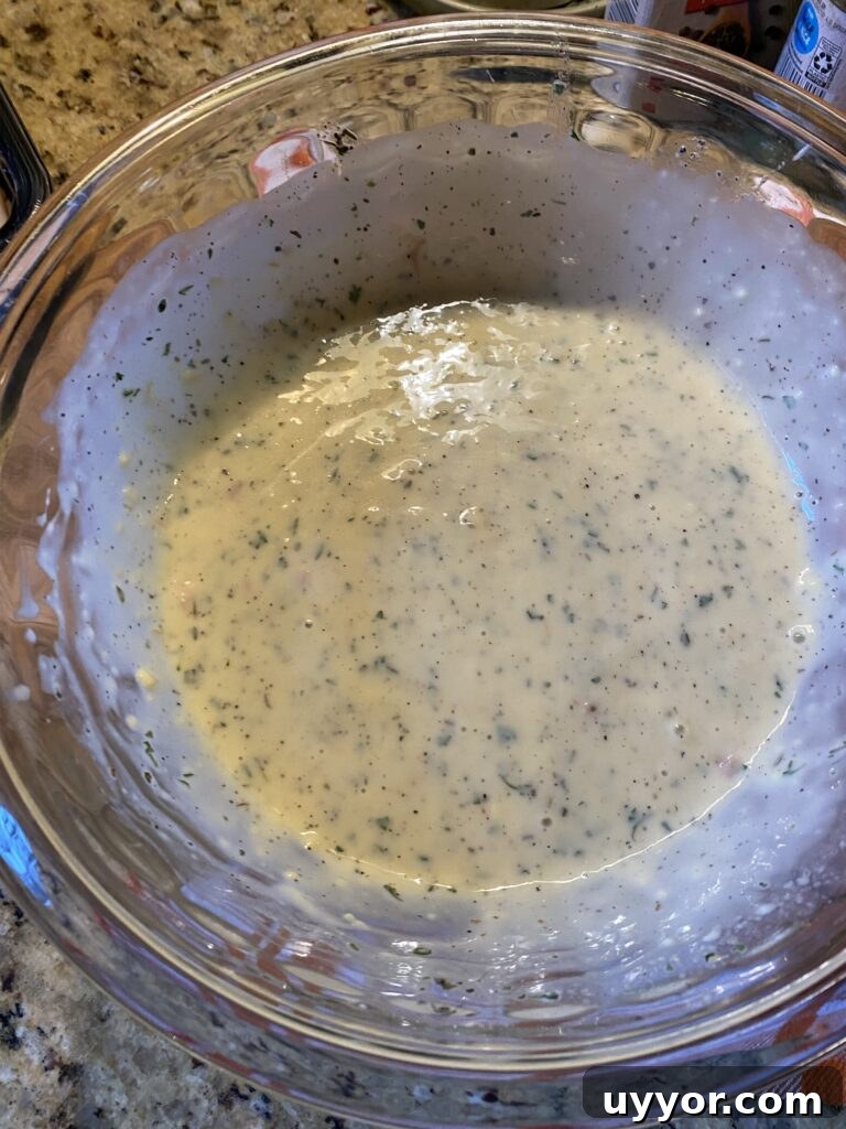 Creamy-Gravy Stuffed Turkey Roll-Ups for Holiday Dinner 9 A glass bowl of creamy gravy