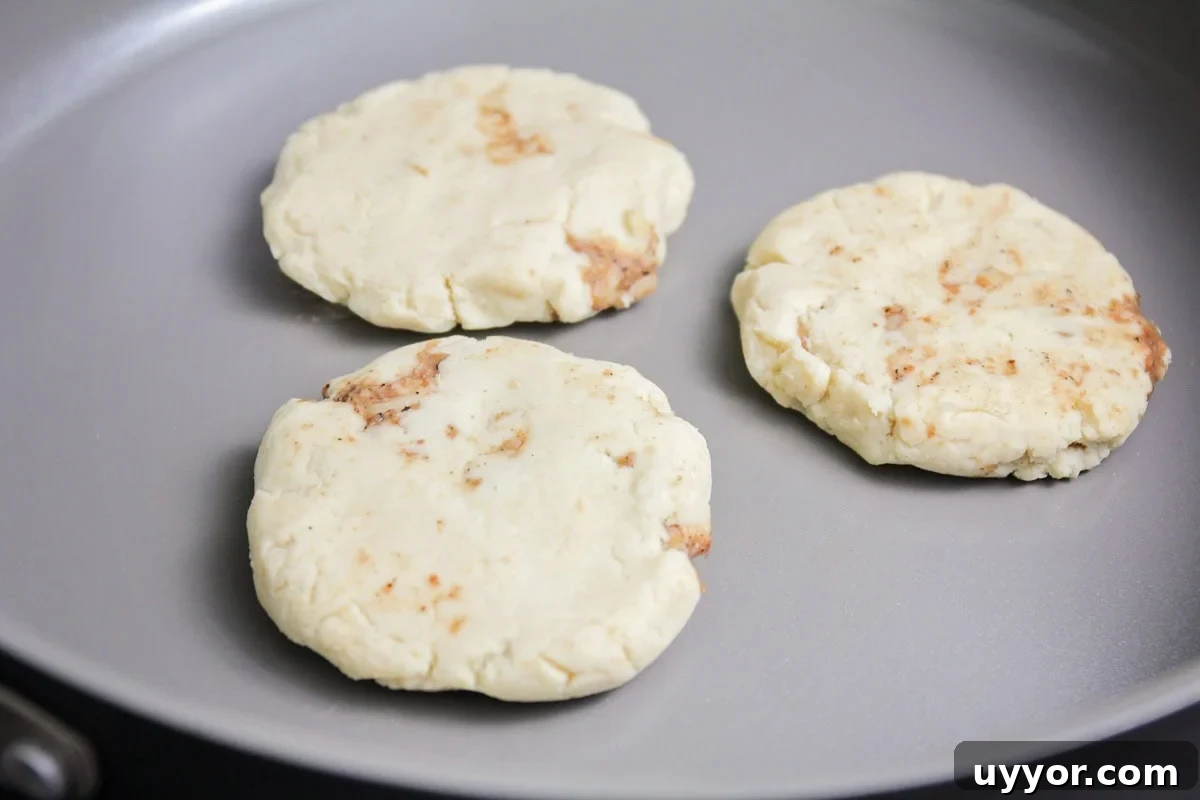 Pupusas recipe being fried on pan.