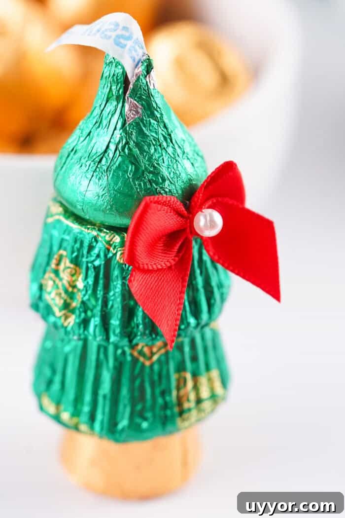 These Reese's Peanut Butter Cup Christmas Trees are so fun and easy to make. Candy Christmas Tree