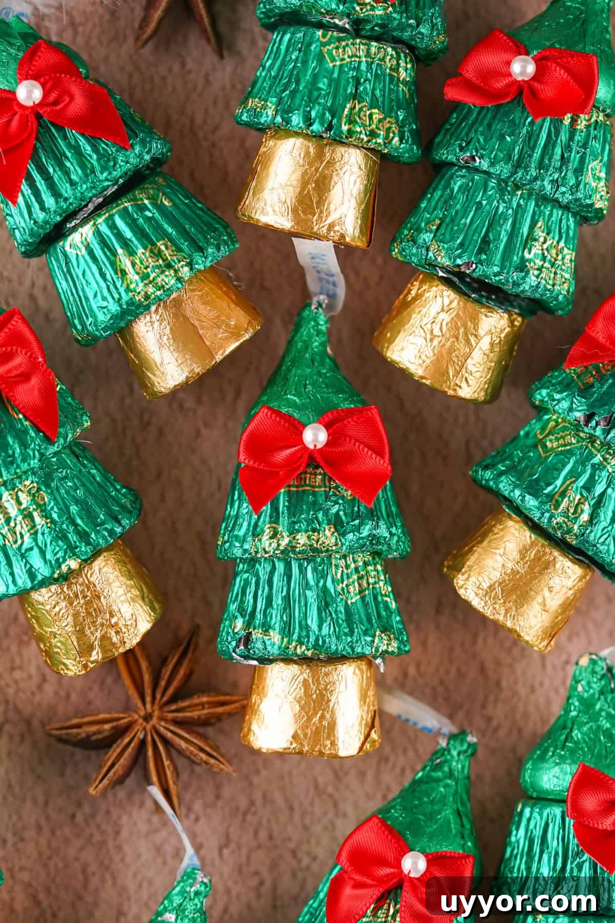 These Reese's Peanut Butter Cup Christmas Trees are so fun and easy to make. Candy Christmas Trees with a bow