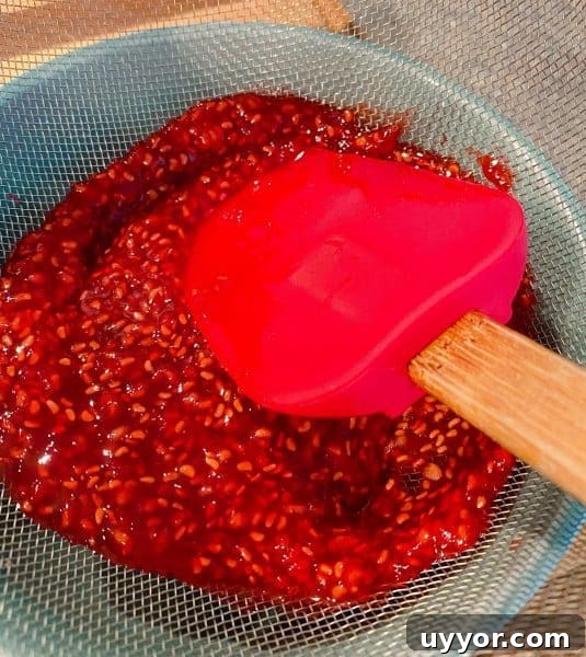Classic Depression-Era Water Pie Recipe You Can Make Today 9 Straining raspberries and pushing down with a spatula to release all the juices.