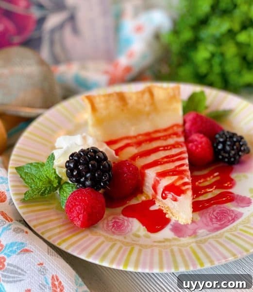 Classic Depression-Era Water Pie Recipe You Can Make Today 11 Slice of Water Pie with Raspberry sauce and fresh berries.