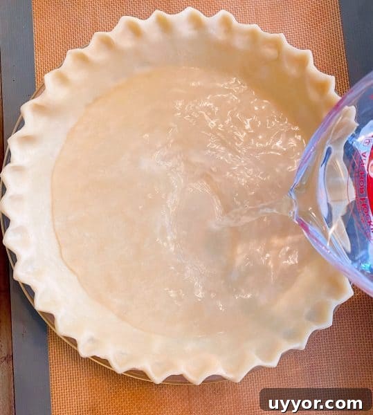 Classic Depression-Era Water Pie Recipe You Can Make Today 4 Pouring water into prepared pie crust.
