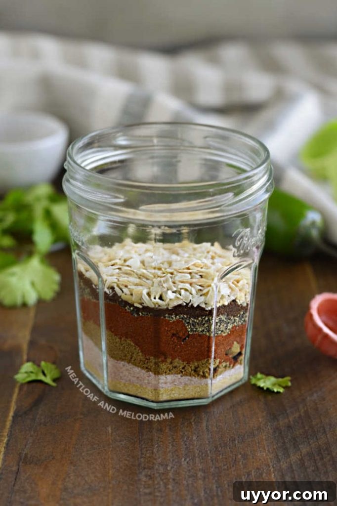 Homemade Taco Seasoning Mix for Flavorful Weeknight Tacos 3 layered spices in a glass jar