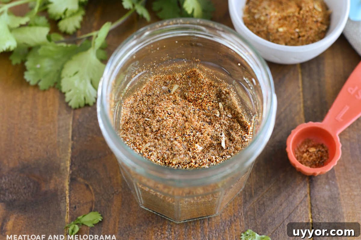 Homemade Taco Seasoning Mix for Flavorful Weeknight Tacos 8 jar of homemade taco seasoning on wood board with cilantro