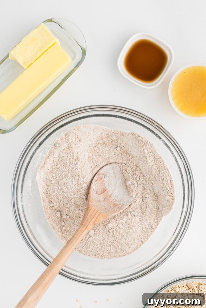 Dry ingredients to make white chocolate pumpkin cookies in a glass bowl.