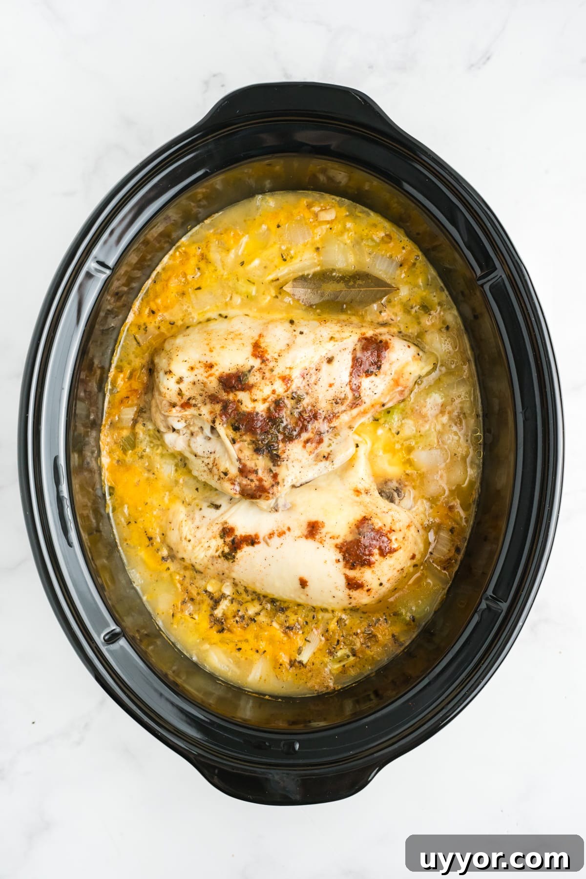 Cooked chicken and sauce in the slow cooker. 