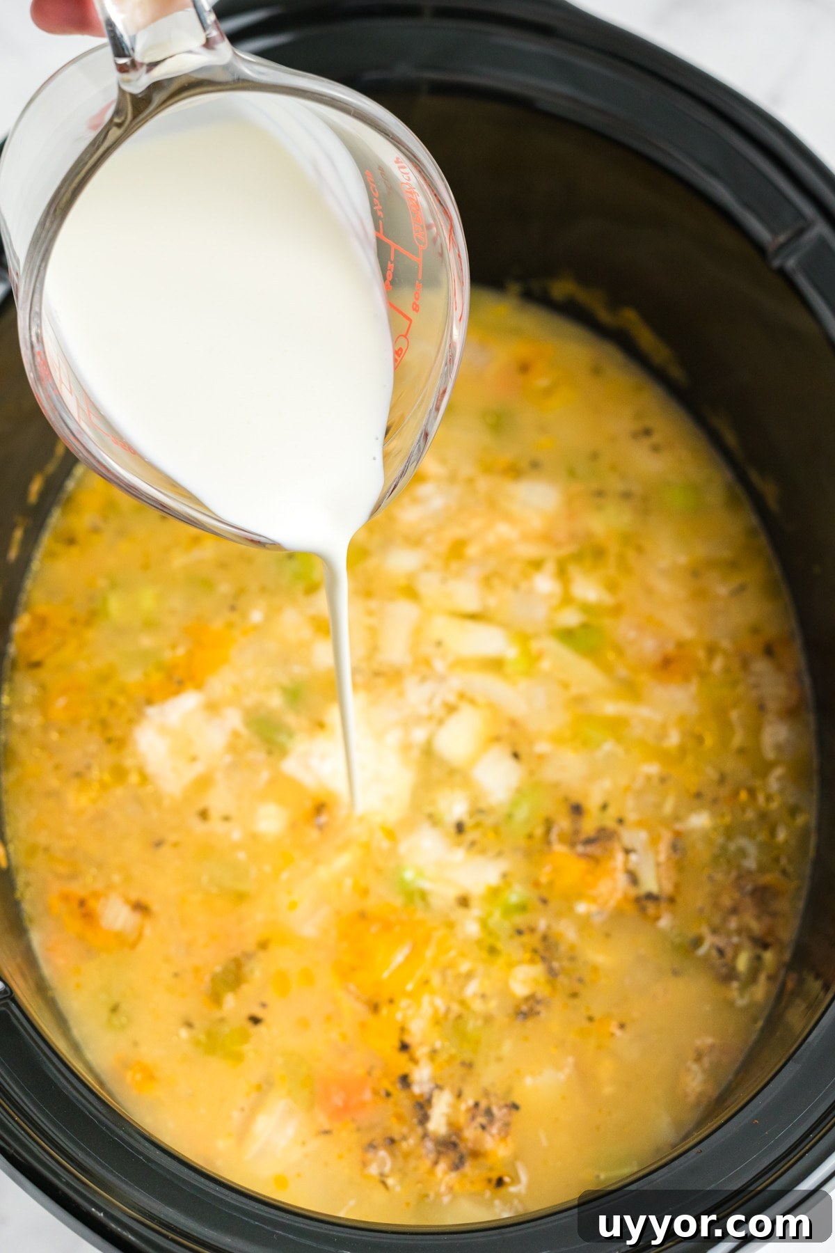 Cream added to the slow cooker. 