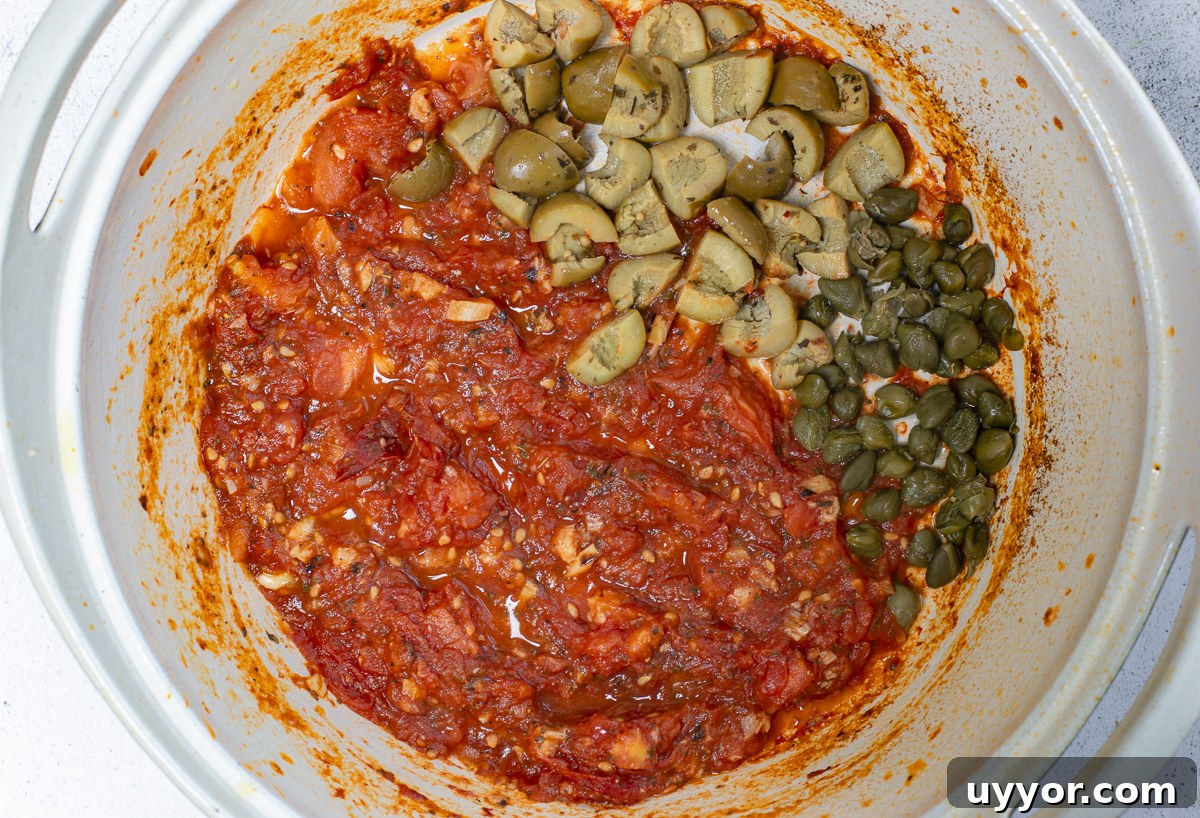 Grilled Caponata: Smoky Sicilian Eggplant with Bold Flavor 11 Tomatoes, Olives and Capers cook in a heavy pot