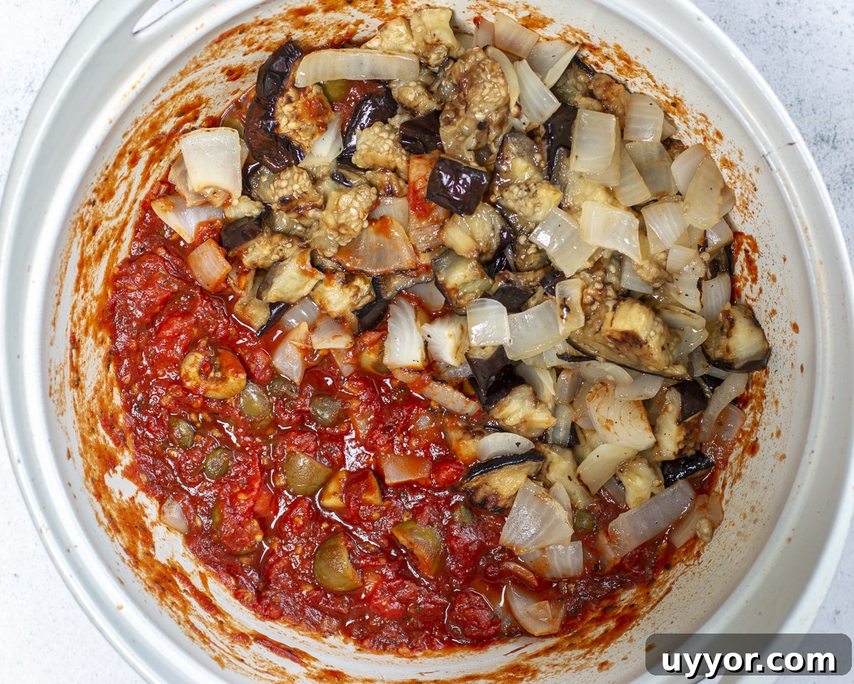 Grilled Caponata: Smoky Sicilian Eggplant with Bold Flavor 12 Adding eggplant and onions to the caponata stew