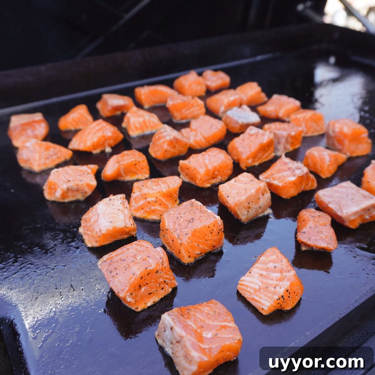 Crispy Cajun Salmon Bites with Zesty Lemon Dipping Sauce 7 salmon bites on the griddle.