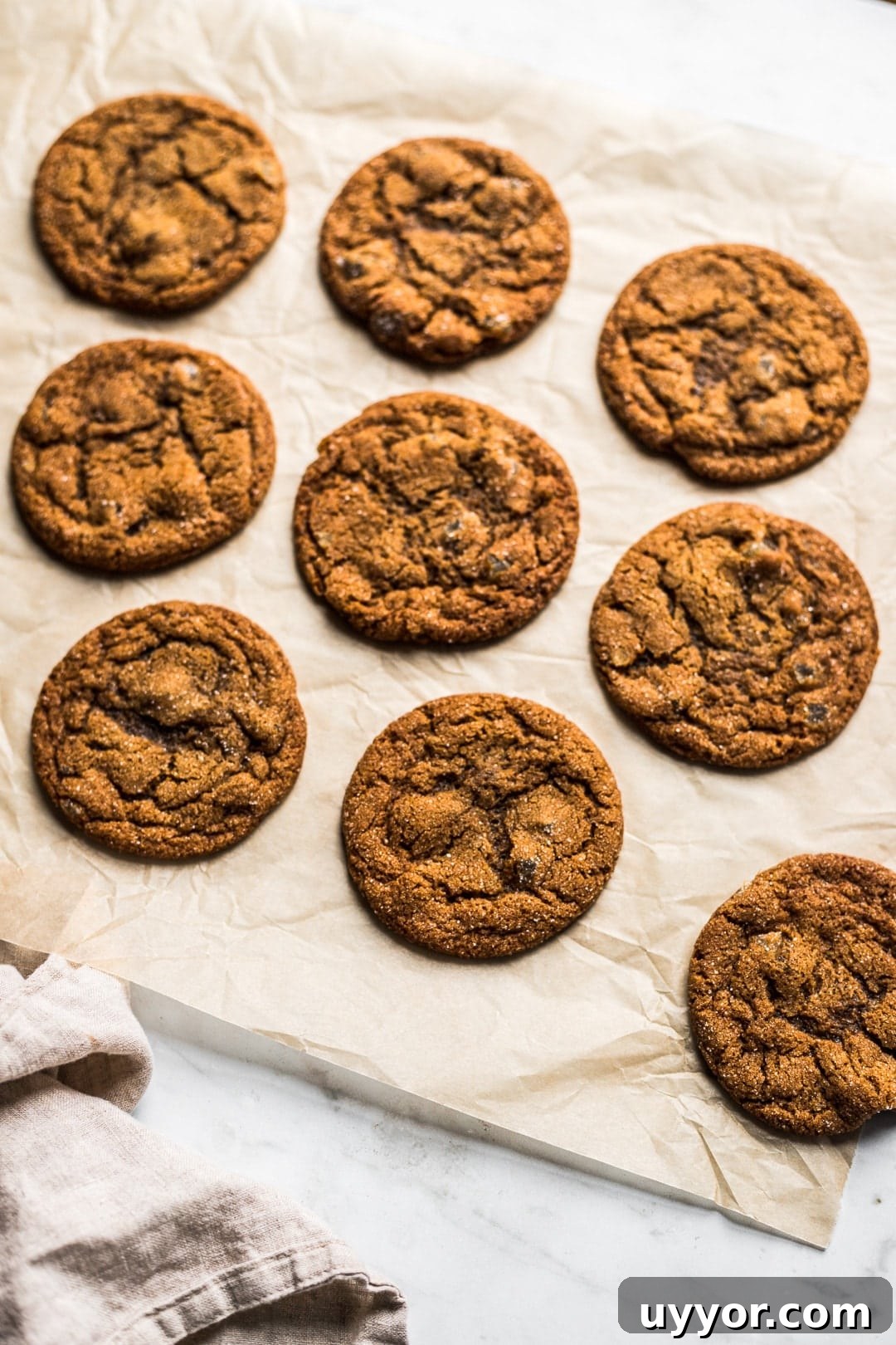 Cookies on natural parchment paper on white marble background