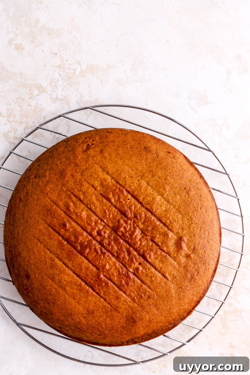 Moist Pumpkin Olive Oil Cake with Cinnamon Glaze 11 A pumpkin cake on a round cooling rack.