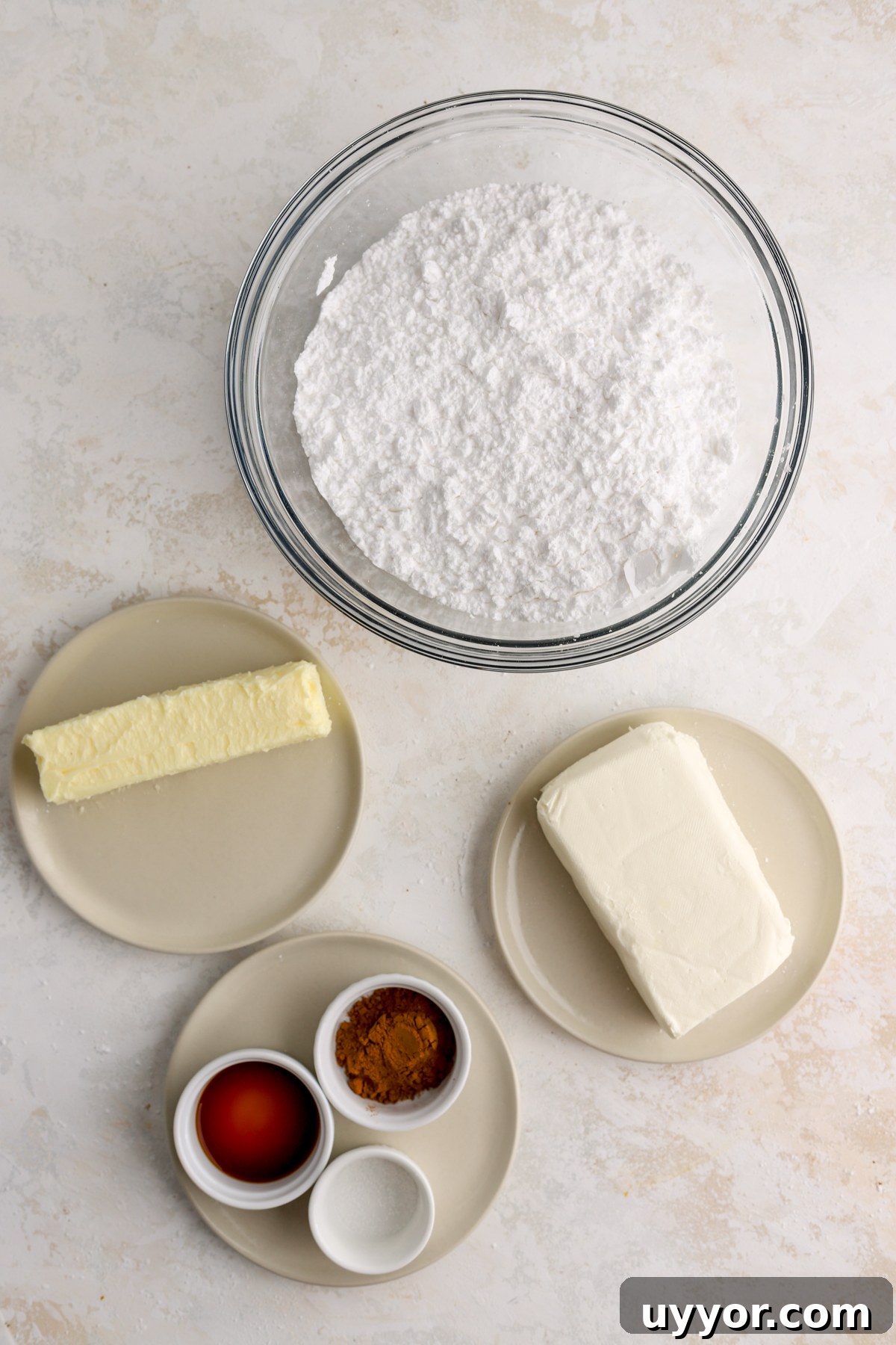 Moist Pumpkin Olive Oil Cake with Cinnamon Glaze 5 A bowl of powdered sugar, a stick of butter, cream cheese and other ingredients.