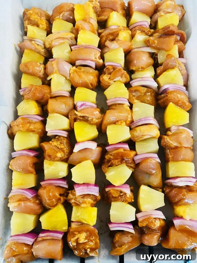 Hawaiian BBQ Chicken Skewers with Pineapple Glaze 4 assembled kabobs before on the grill