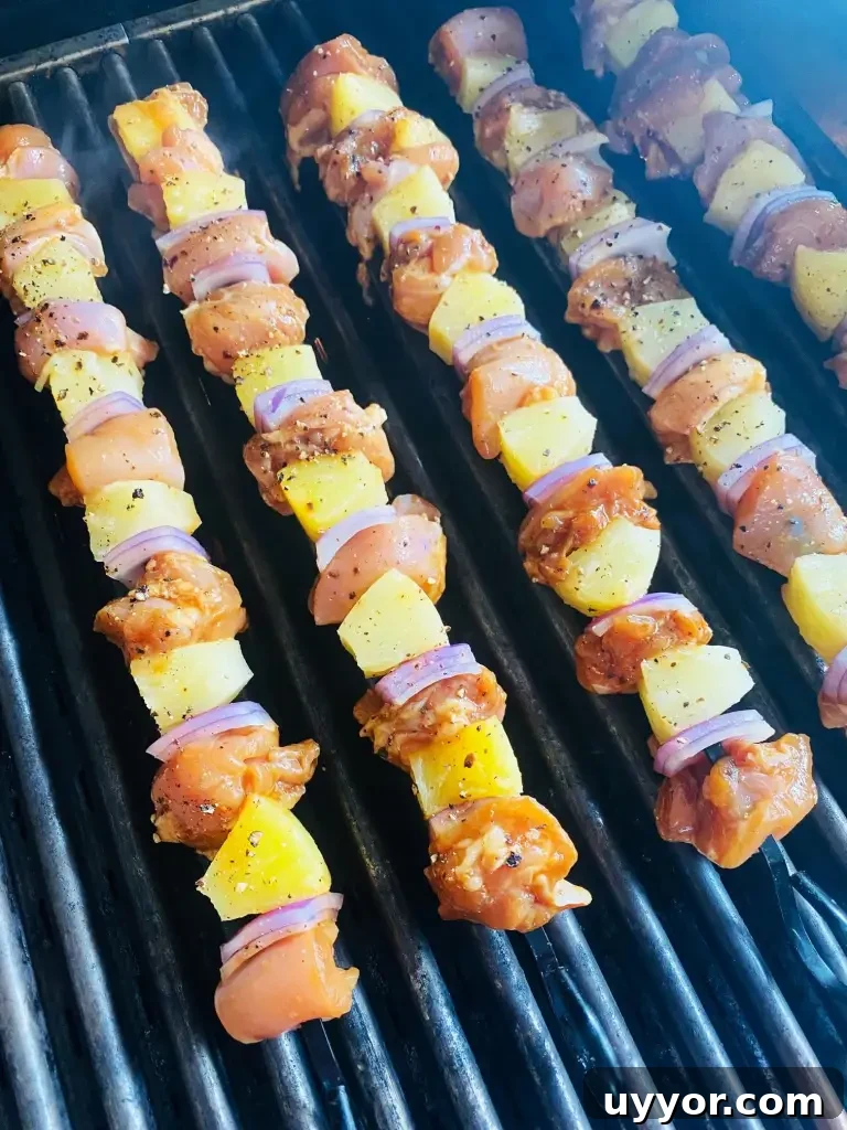 Hawaiian BBQ Chicken Skewers with Pineapple Glaze 5 skewers on the grill before cooking