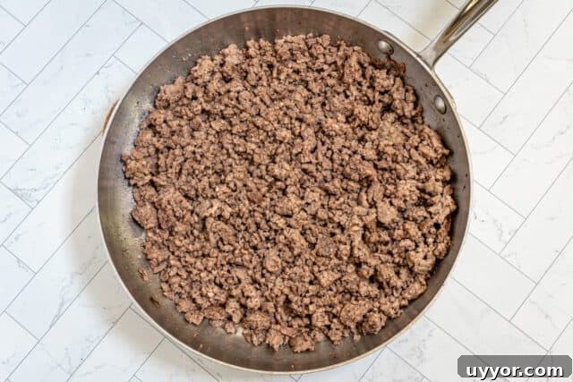 Cooked ground beef in a skillet.