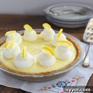 Luscious sour cream lemon custard is filled in a graham cookie crust and topped with whipped cream.