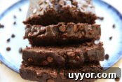 Hearty Ham Bone and Lentil Soup Recipe for Deep Flavor 13 Banana chocolate bread sliced and sitting on a plate with chocolate chips scattered around the bread.