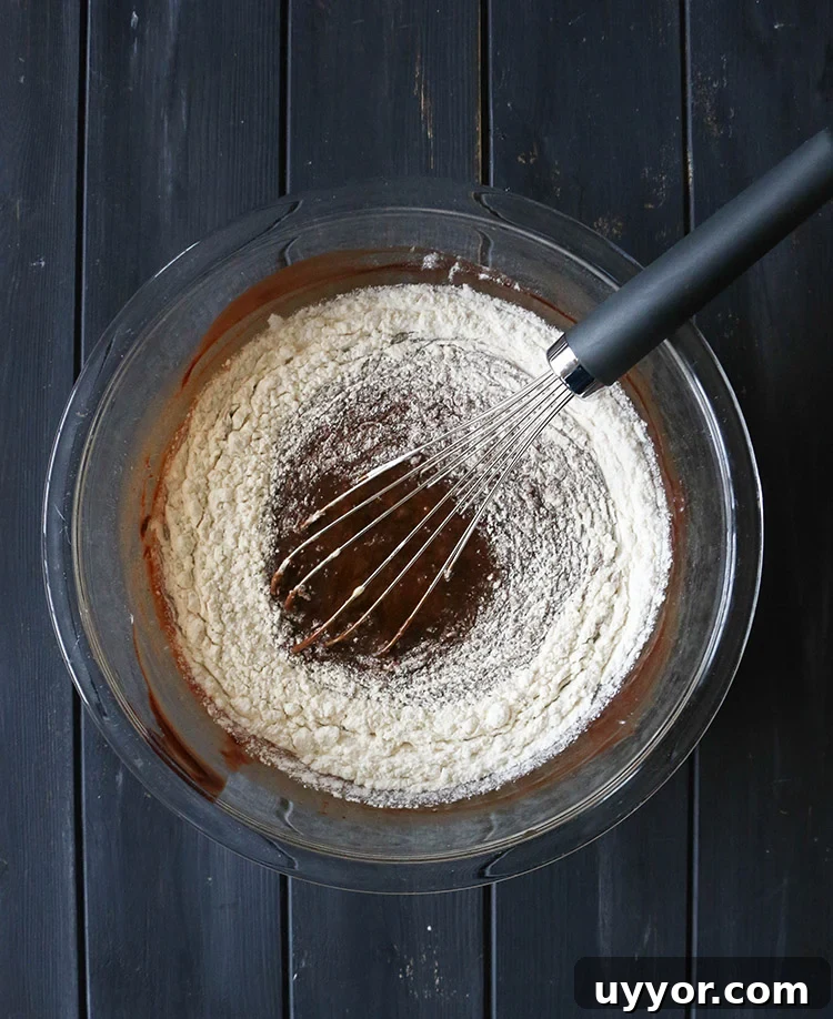 Spicy Chocolate Lava Cakes with Molten Centers 11 Whisking flour into chocolate cake batter