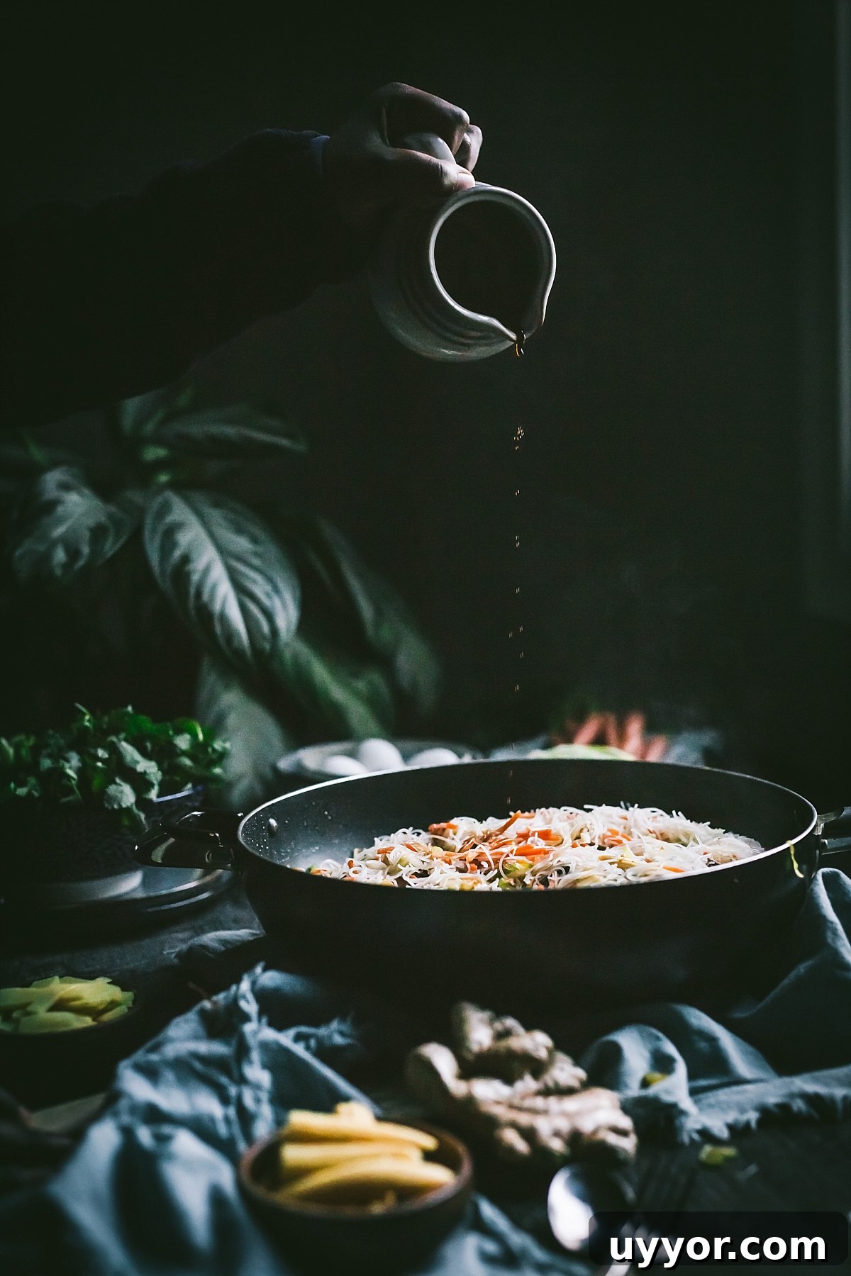 Authentic Filipino Chicken Pancit Recipe with Stir-Fry Noodles 12 pouring soy sauce into chicken pancit