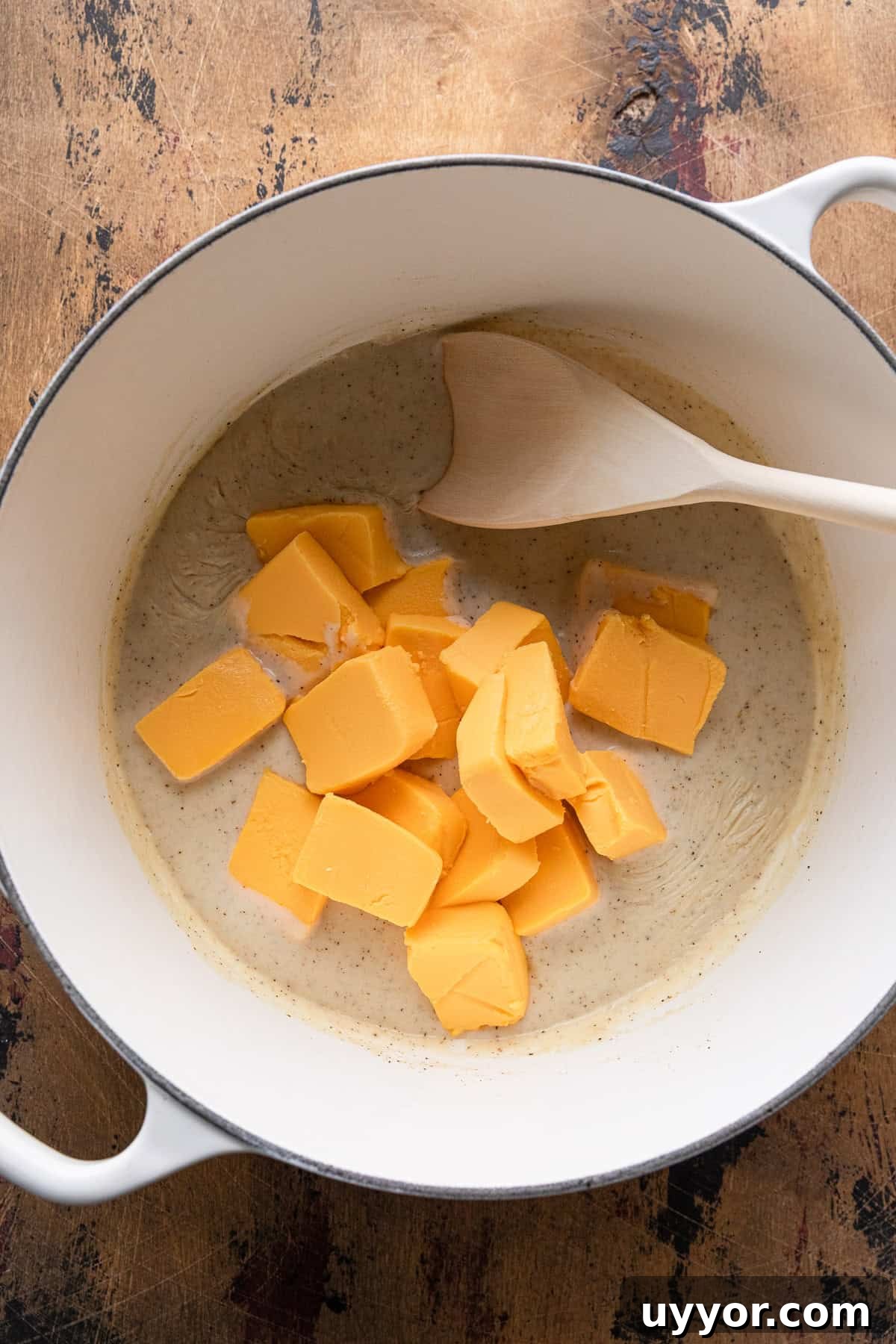 Adding velveeta to make the cheese sauce.